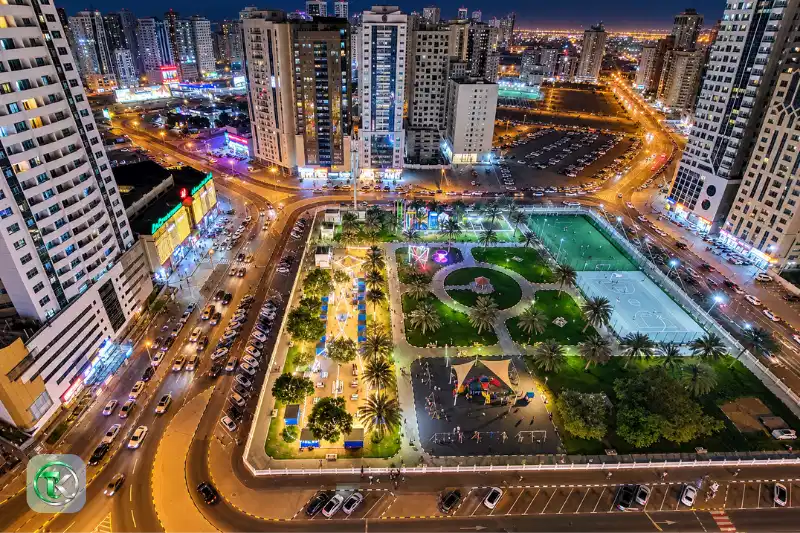 Al Nahda Park Sharjah at night with illuminated sports facilities