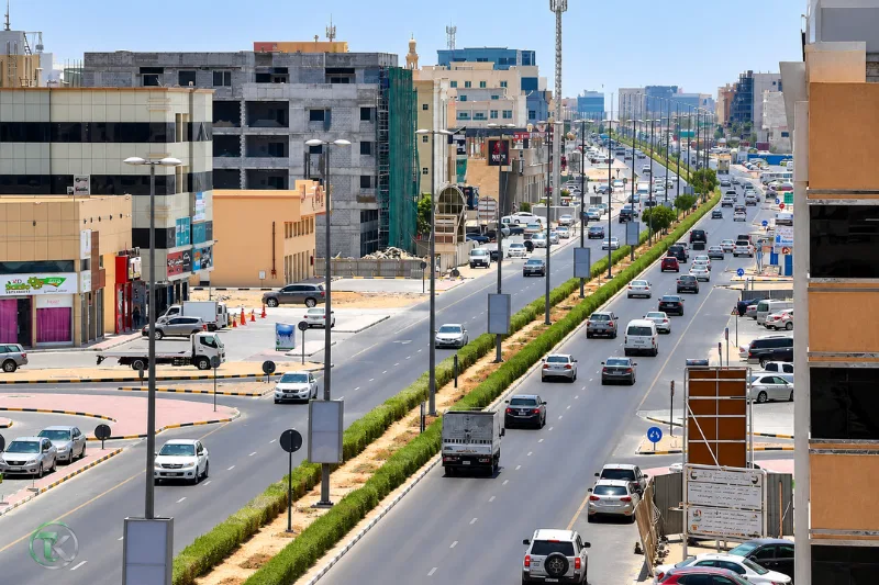 Busy traffic and commercial buildings along Sheikh Ammar Bin Humaid Street in Ajman