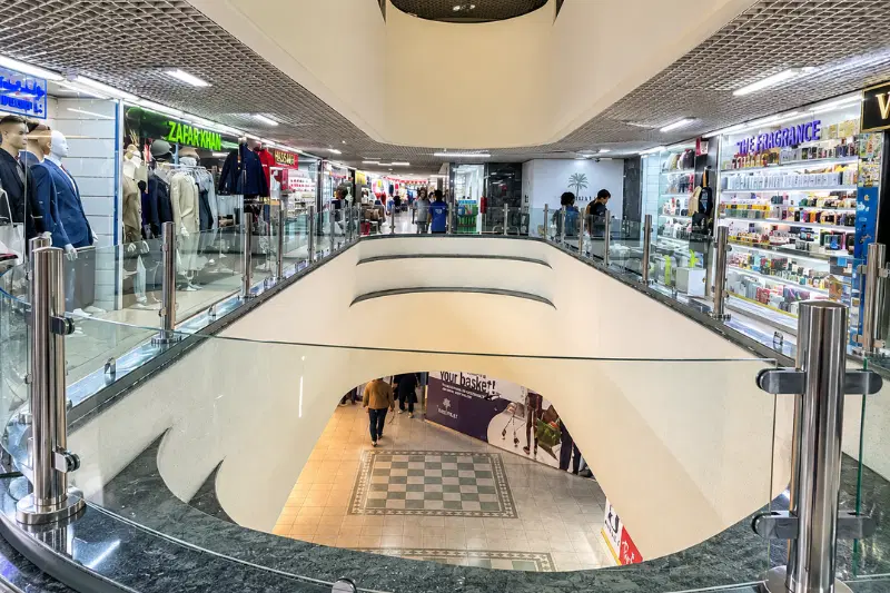 Interior view of Hamdan Centre with retail shops and upper-level walkway in Abu Dhabi