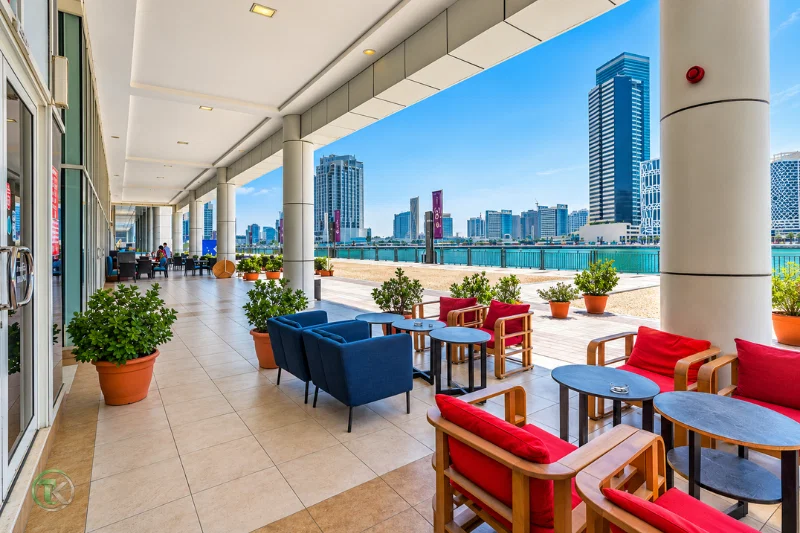 Outdoor waterfront seating area near Lake Central Tower in Business Bay