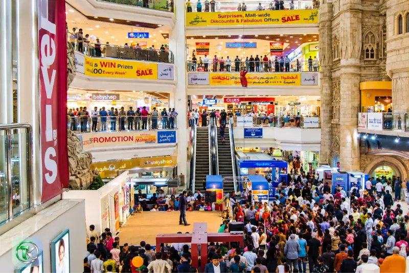 Crowded Lamcy Plaza Dubai interior with escalators and multiple shopping levels