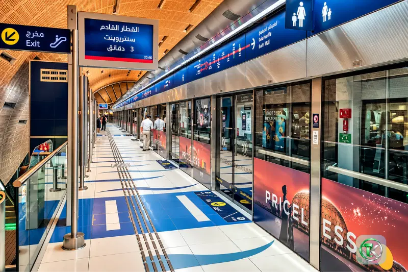 Dubai Metro platform at Internet City Station with train doors and passenger route signs