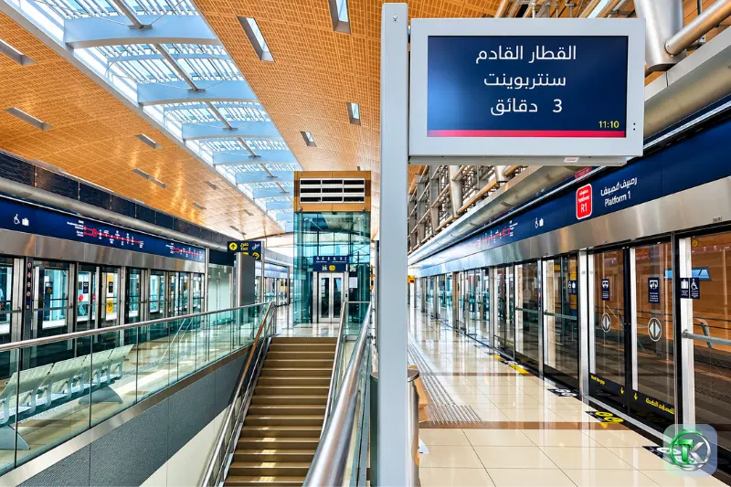 Dubai Metro platform with glass platform doors, passenger information displays and train arrival timings