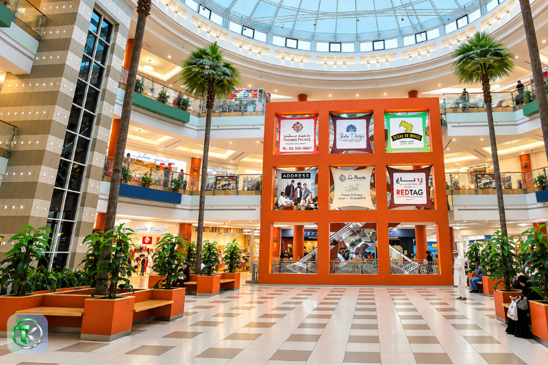 Mazyad Mall interior atrium with shops, palm trees and multi-level walkways