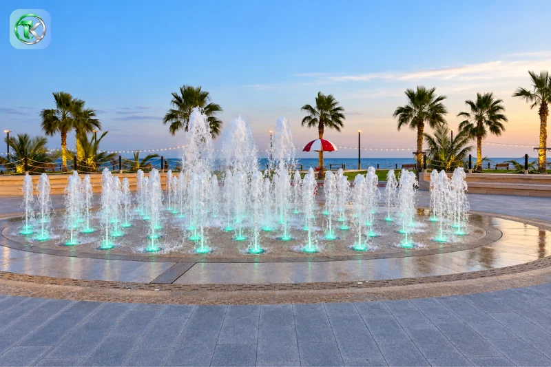 Umbrella Beach Fujairah illuminated fountain with palm trees and seaside promenade