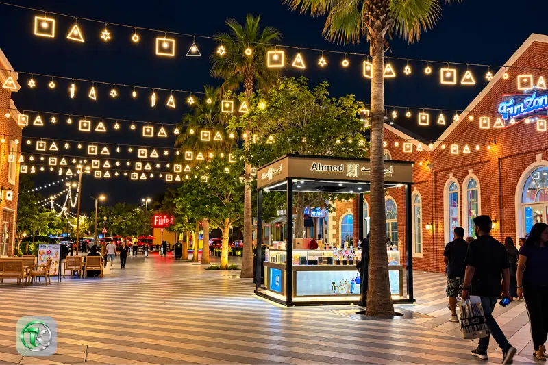 Umbrella Beach Fujairah illuminated promenade with restaurants, decorative lights and outdoor seating
