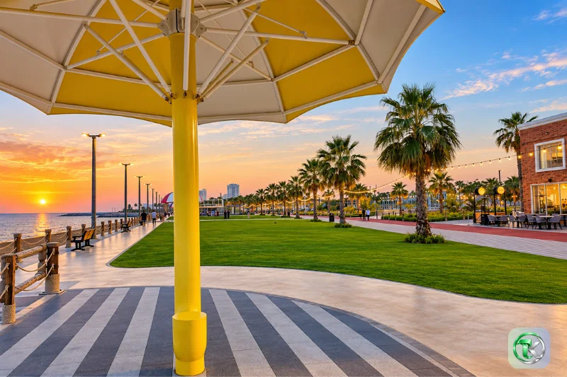 Umbrella Beach Fujairah yellow shade canopy overlooking the waterfront promenade and landscaped lawns